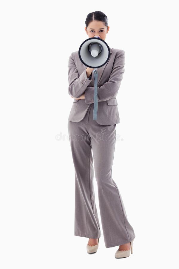 Portrait of a businesswoman using a megaphone against a white background