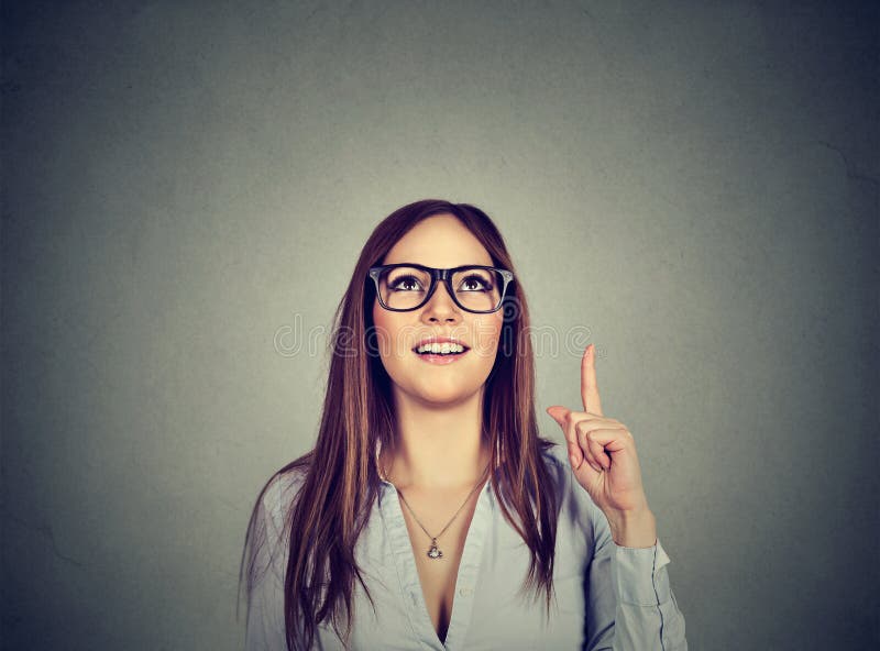 Casual woman pointing up has an idea royalty free stock photo Casual woman pointing up has an idea royalty free stock photo
