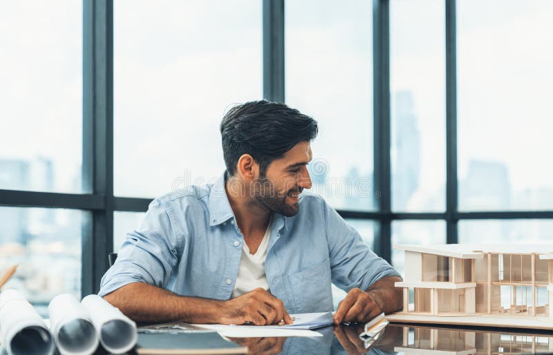 Caucasian Architect Engineer Designs House Construction on Blueprint