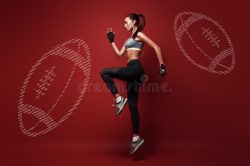 Healthy mind in a healthy body. Young, attractive sportswoman standing in the position for a run, isolated over red stock images Healthy mind in a healthy body. Young, attractive sportswoman standing in the position for a run, isolated over red stock images