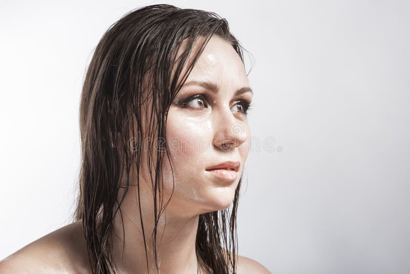 Portrait Of Caucasian Sensual Brunette Girl Showing Wet And Shining Skin And Wet Hair Stock