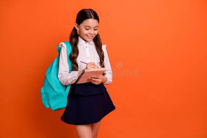 Portrait of charming nice kid child hold hand organize note book feel positive poems author isolated wear modern skirt.