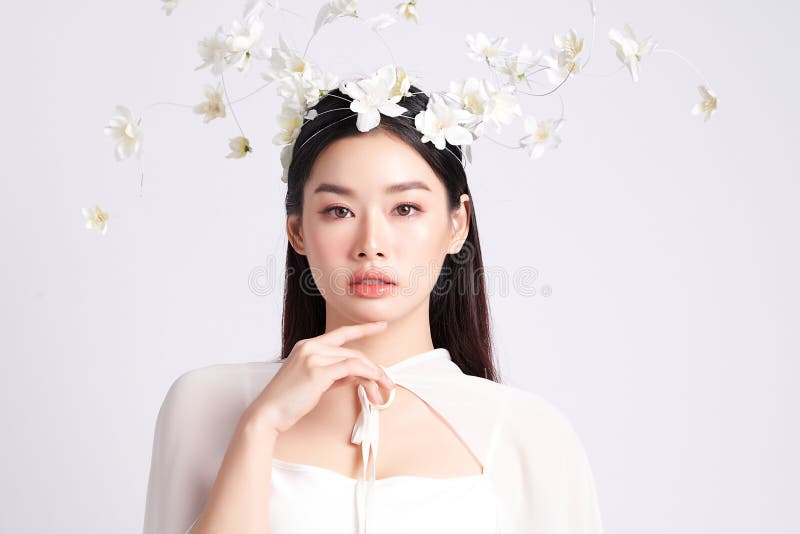 Portrait of a charming young asian lady with a flower crown in a vintage blouse. on white background