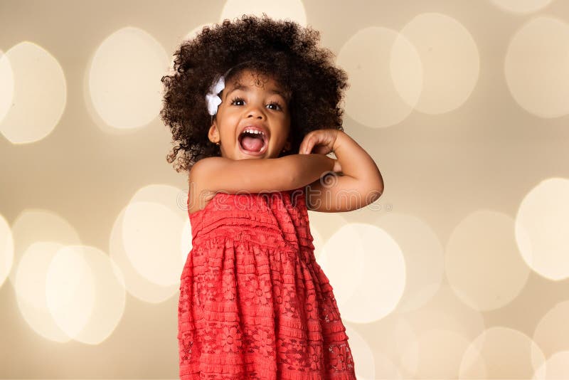 Portrait Of Cheerful African American Girl Over Blurred Lights