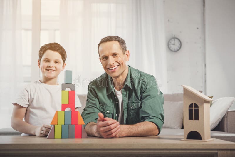Happy dad and boy playing in living room royalty free stock image Happy dad and boy playing in living room royalty free stock image