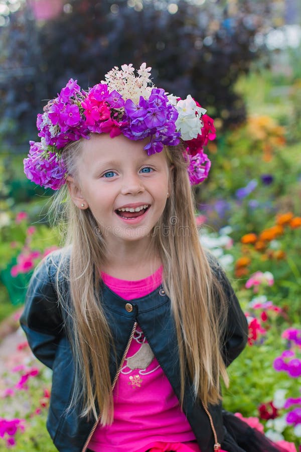 Portrait of a cheerful girl with a wreath of flowers on her head stock images Portrait of a cheerful girl with a wreath of flowers on her head stock images