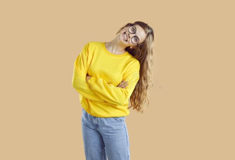 Portrait of cheerful and goofy girl with wide funny and crazy smile on light beige background. stock photos