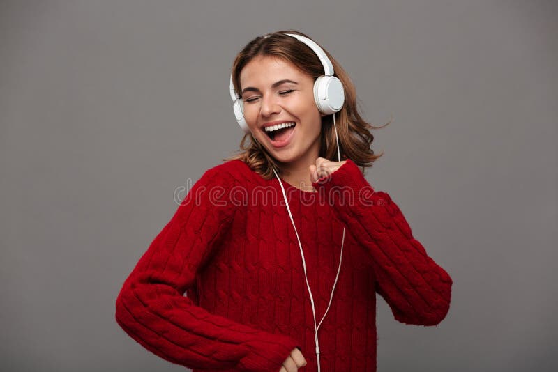 Portrait of a cheerful happy girl in red sweater