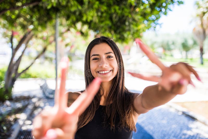 Portrait Of A Cheerful Woman Lovely Woman Showing Victory Or Peace