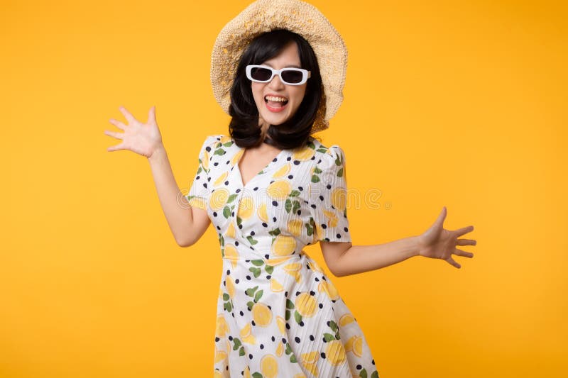 Portrait cheerful young asian woman happy smile dressing springtime female style fashion and sunglasses isolated on yellow