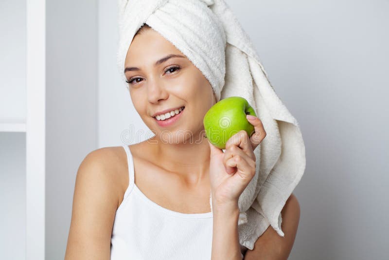 Portrait of a Cheerful Young Woman with Perfect Smile Eating Green ...