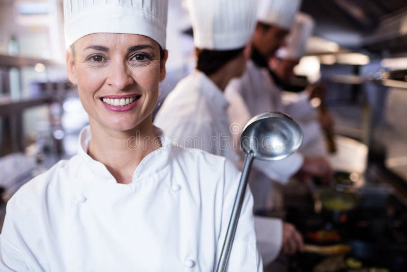 Portrait of chef holding a ladle stock photo Portrait of chef holding a ladle stock photo