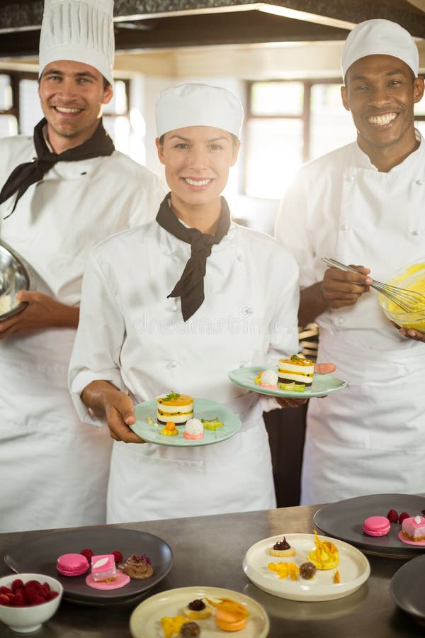 Portrait of Chefs Team Finishing Dessert Plates Stock Image Image of