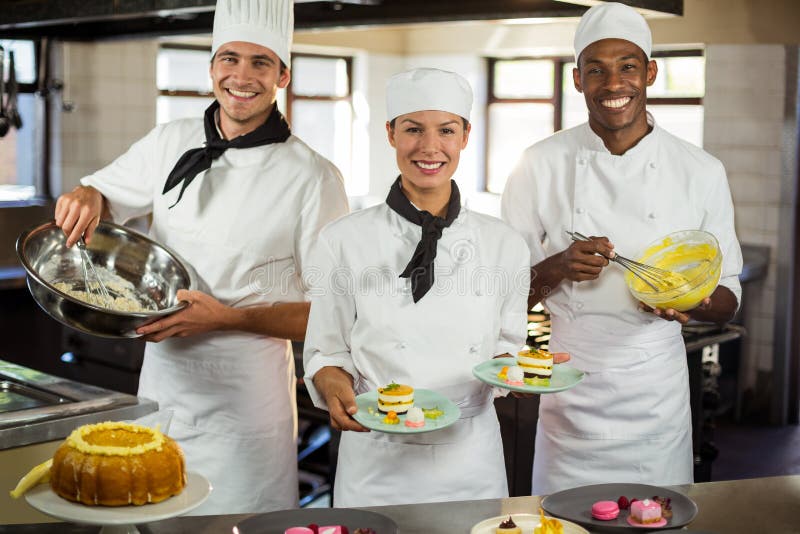 Portrait of Chefs Team Finishing Dessert Plates Stock Image Image of