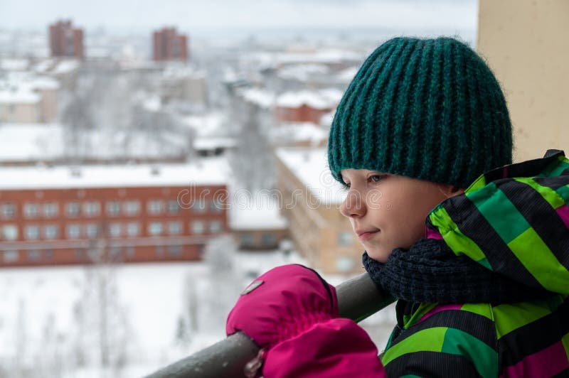 Portrait of a child on the balcony of a high-rise building stock photography