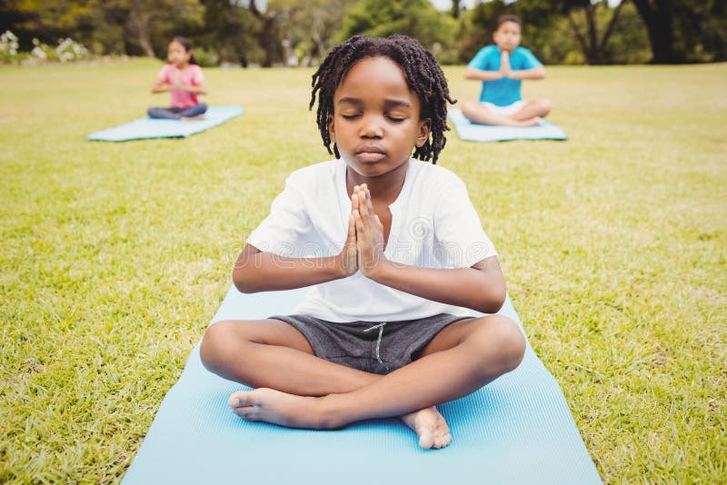 Portrait of child doing yoga with friends royalty free stock photography