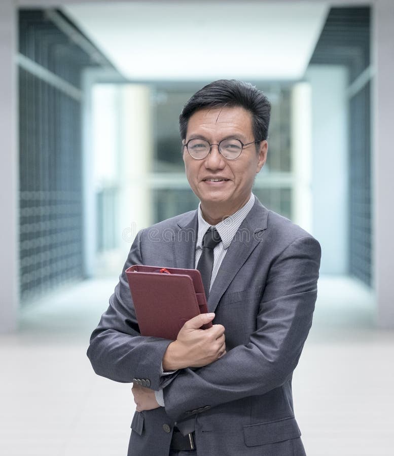 Portrait of a Chinese Businessman Holding a Diary Stock Photo Image