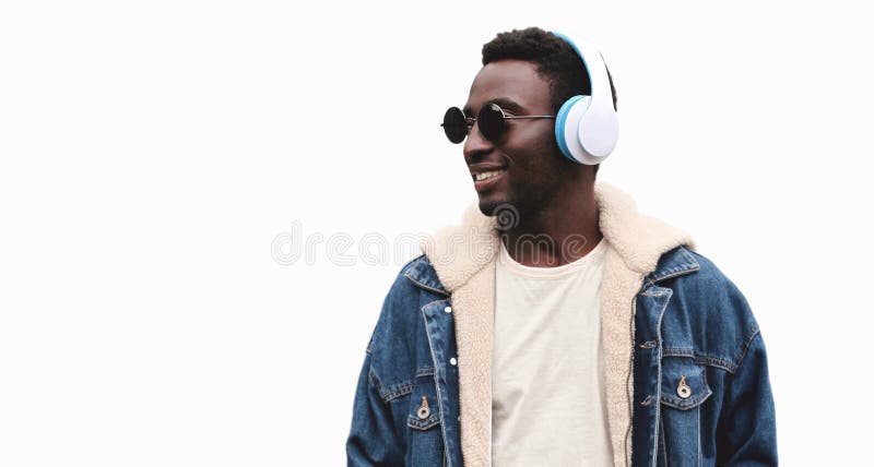 Portrait of happy smiling african man in wireless headphones listening to music isolated on a white background