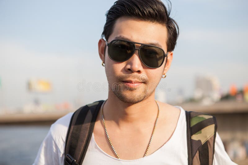 Portrait close up head shot of handsome asian man standing with