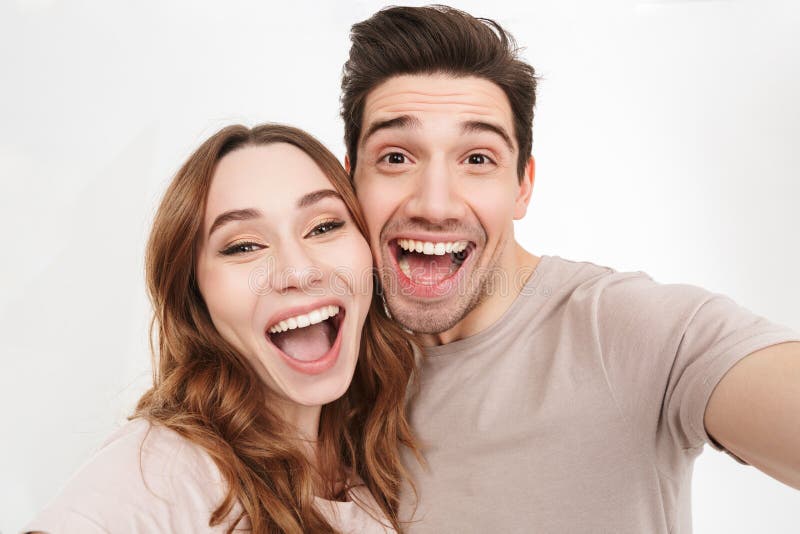 Portrait closeup of young and beautiful couple expressing joy on