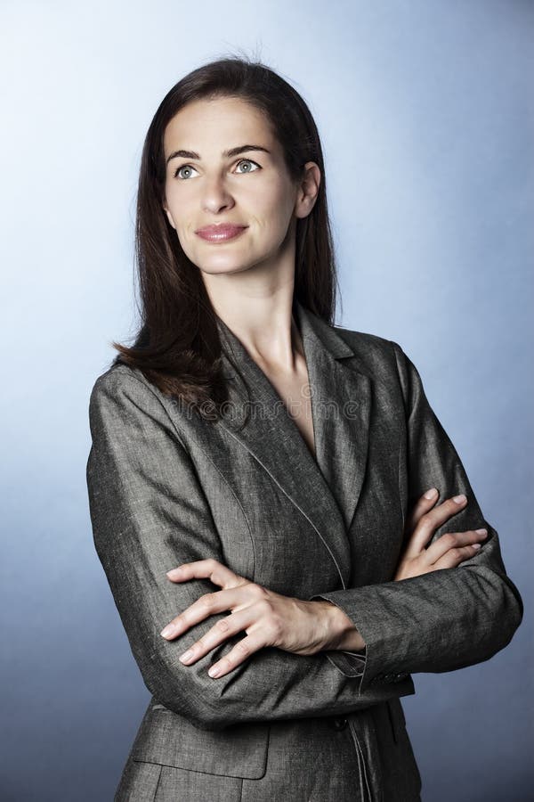 Portrait of confident business woman looking up.