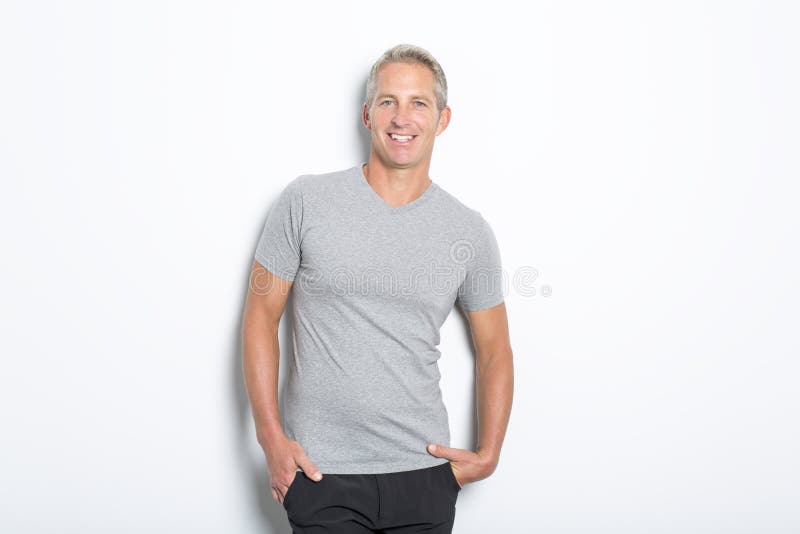 Portrait of confident mature man standing on white background