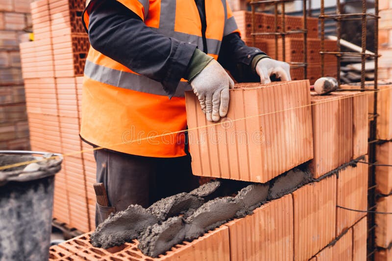 Portrait of Construction Worker Bricklayer Using Bricks and Mortar for