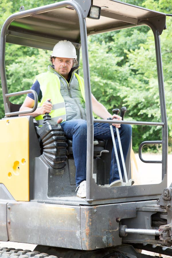 Excavator Driver Man Operator with Metal Tracks Unloading Soil at