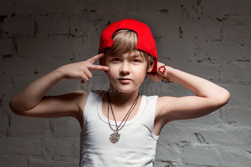 Portrait of cool young hip hop boy in red hat and red pants royalty free stock images