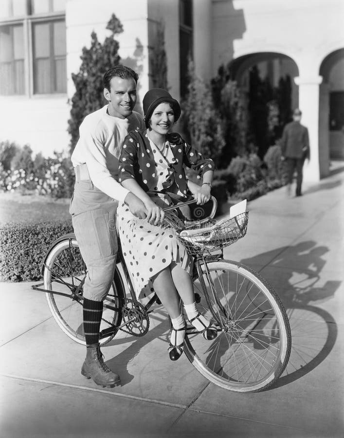 Portrait of couple on bicycle together (All persons depicted are no longer living and no estate exists. Supplier grants that there will be no model release issues.)