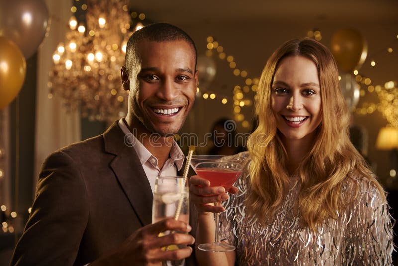 Portrait of Couple with Drinks Enjoying Cocktail Party Stock Photo