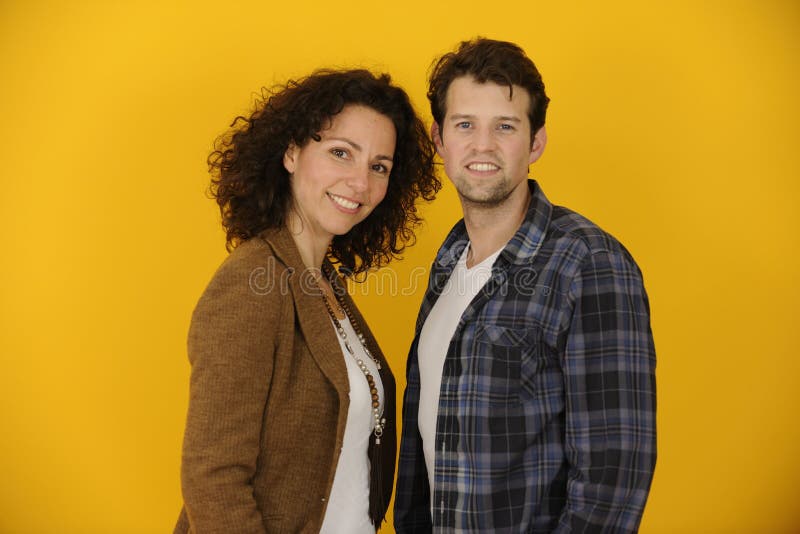 Portrait of couple or partners on yellow background