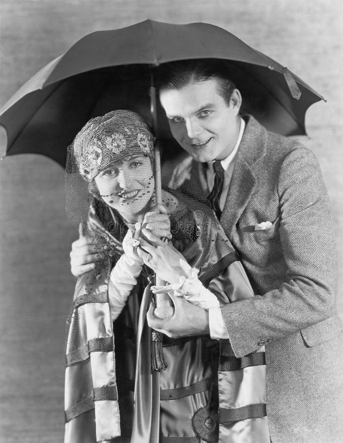 Portrait of couple under umbrella (All persons depicted are no longer living and no estate exists. Supplier grants that there will be no model release issues.)