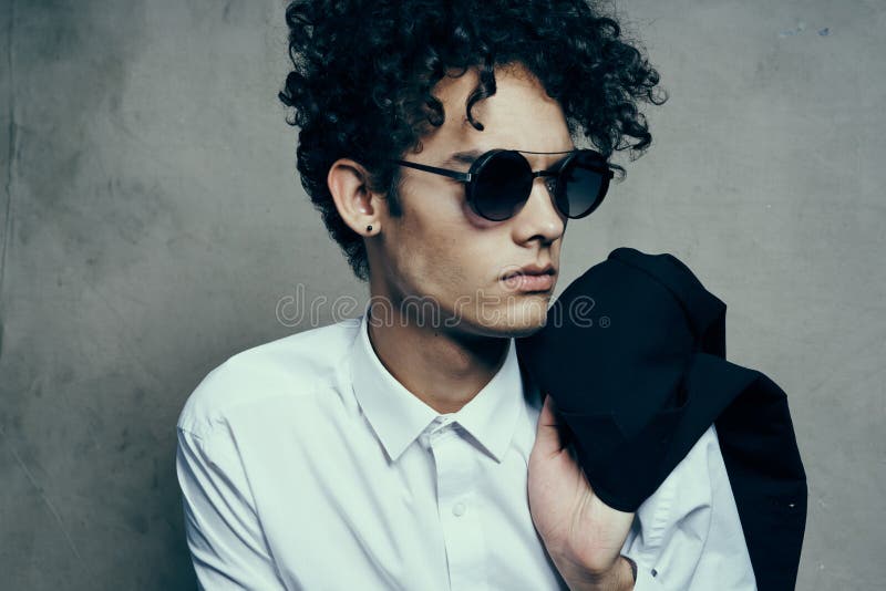 Portrait of a Curly-haired Guy in a Shirt with a Jacket on His Shoulder ...