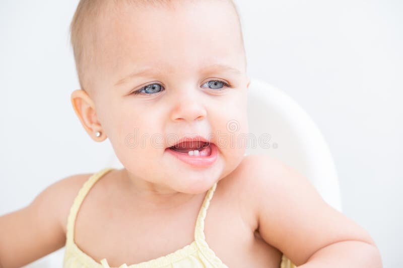 Portrait of Cute Baby Girl Smiling with First Milk Teeth. Healthy