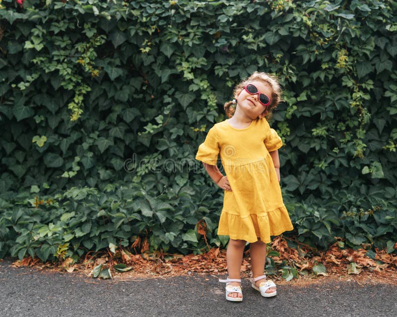 Portrait of Cute Blond Girl in Clothing Posing in Sunny Day and Looking at the Camera at outdoors. stock image Portrait of Cute Blond Girl in Clothing Posing in Sunny Day and Looking at the Camera at outdoors. stock image
