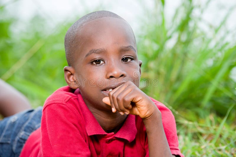 Portrait of cute boy lying on fresh green herbs stock image Portrait of cute boy lying on fresh green herbs stock image