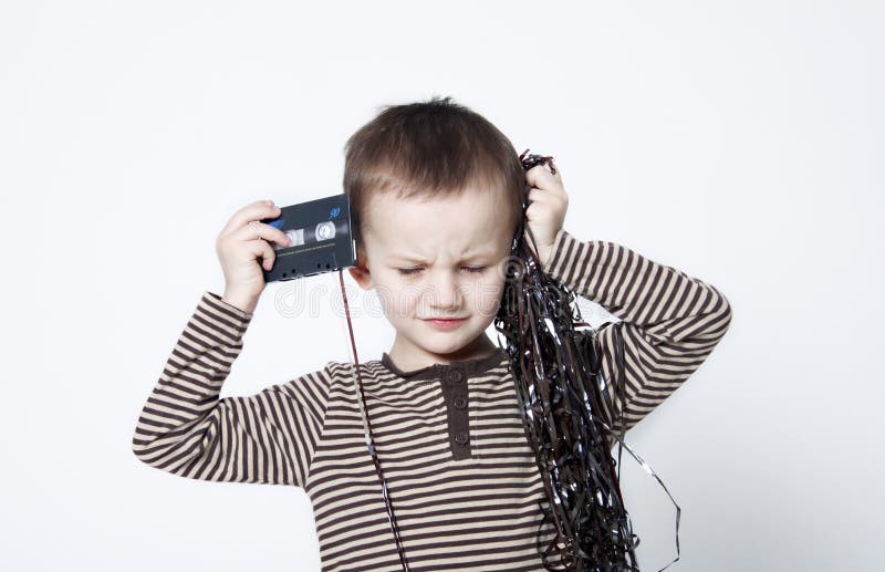 Portrait of cute boy playing with old tape