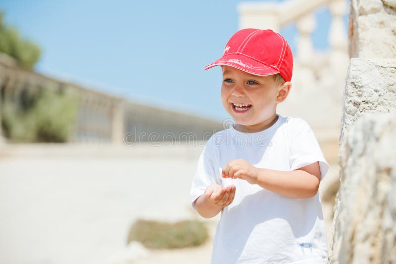 Portrait of cute boy in a red cap