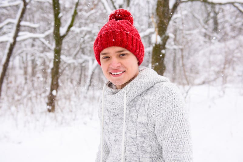 Portrait of cute boy in red knitted hat outdoors