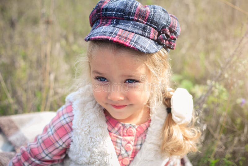 Portrait of a cute cheerful little girl on a nature.