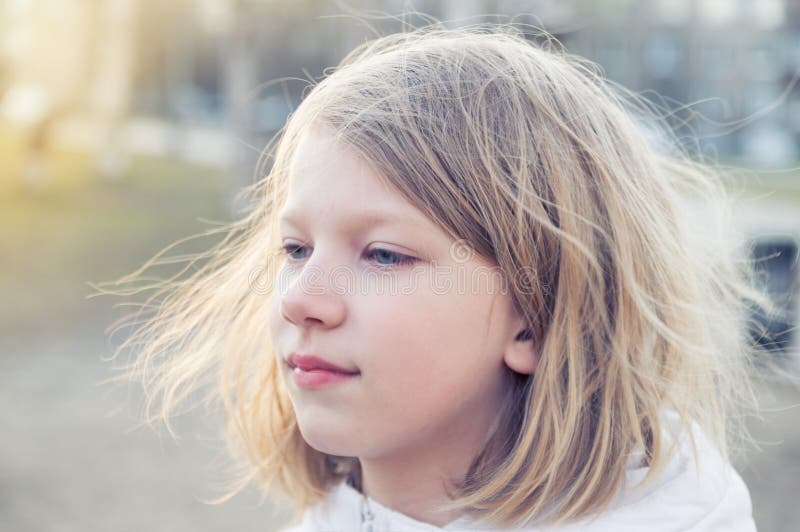 Portrait of a cute eight-year-old girl at sunset stock images