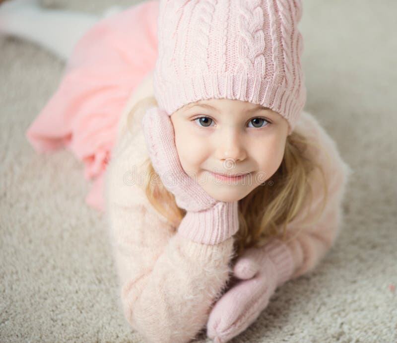 Portrait of cute girl in hat and gloves at Christmas time royalty free stock images
