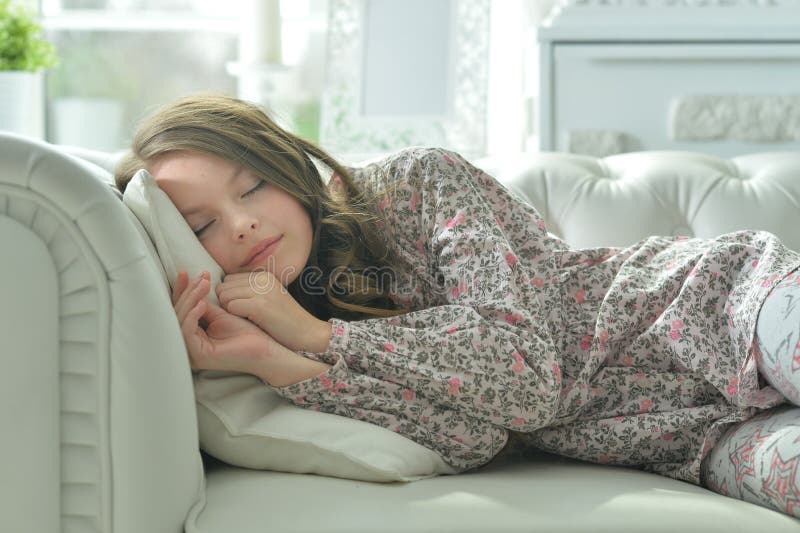 Portrait of cute girl sleeping on sofa