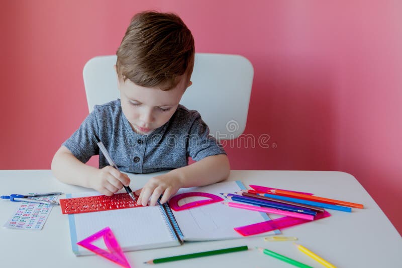 Make your homework. Children write with Pencils. Kid writing with Bookstand. Child writing homework. Children write Pencil Words.