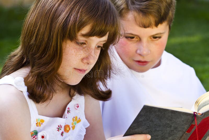 Portrait of cute kids reading books