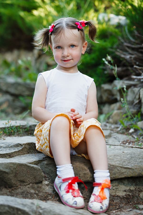 Portrait of a Cute Little Girl on the Background of Nature. she`s ...