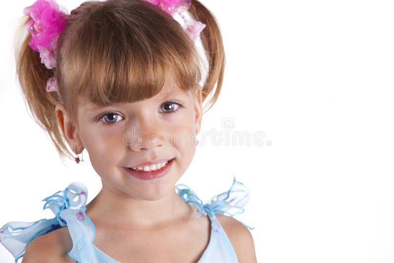 Portrait of a cute little girl in blue dress