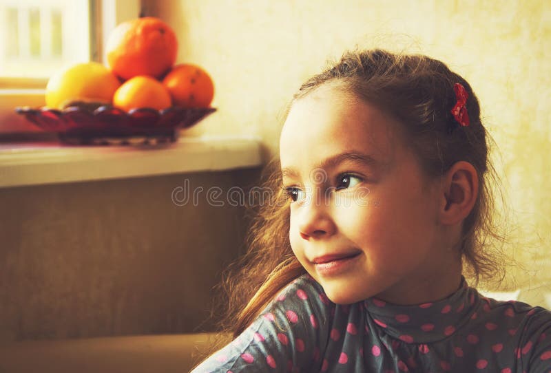 Portrait of cute little girl dreaming. Toned