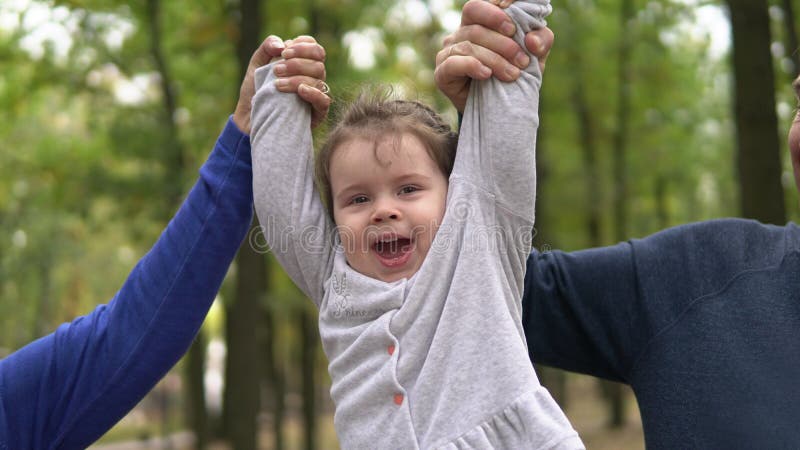 Portrait of cute little girl hanging on hands with funny look outdoors royalty free stock photos Portrait of cute little girl hanging on hands with funny look outdoors royalty free stock photos